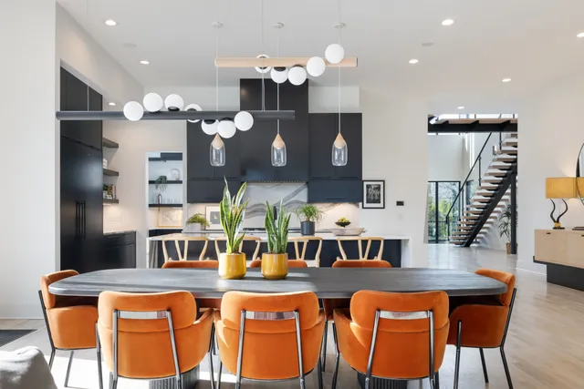a living room with furniture a dining table and a flat screen tv
