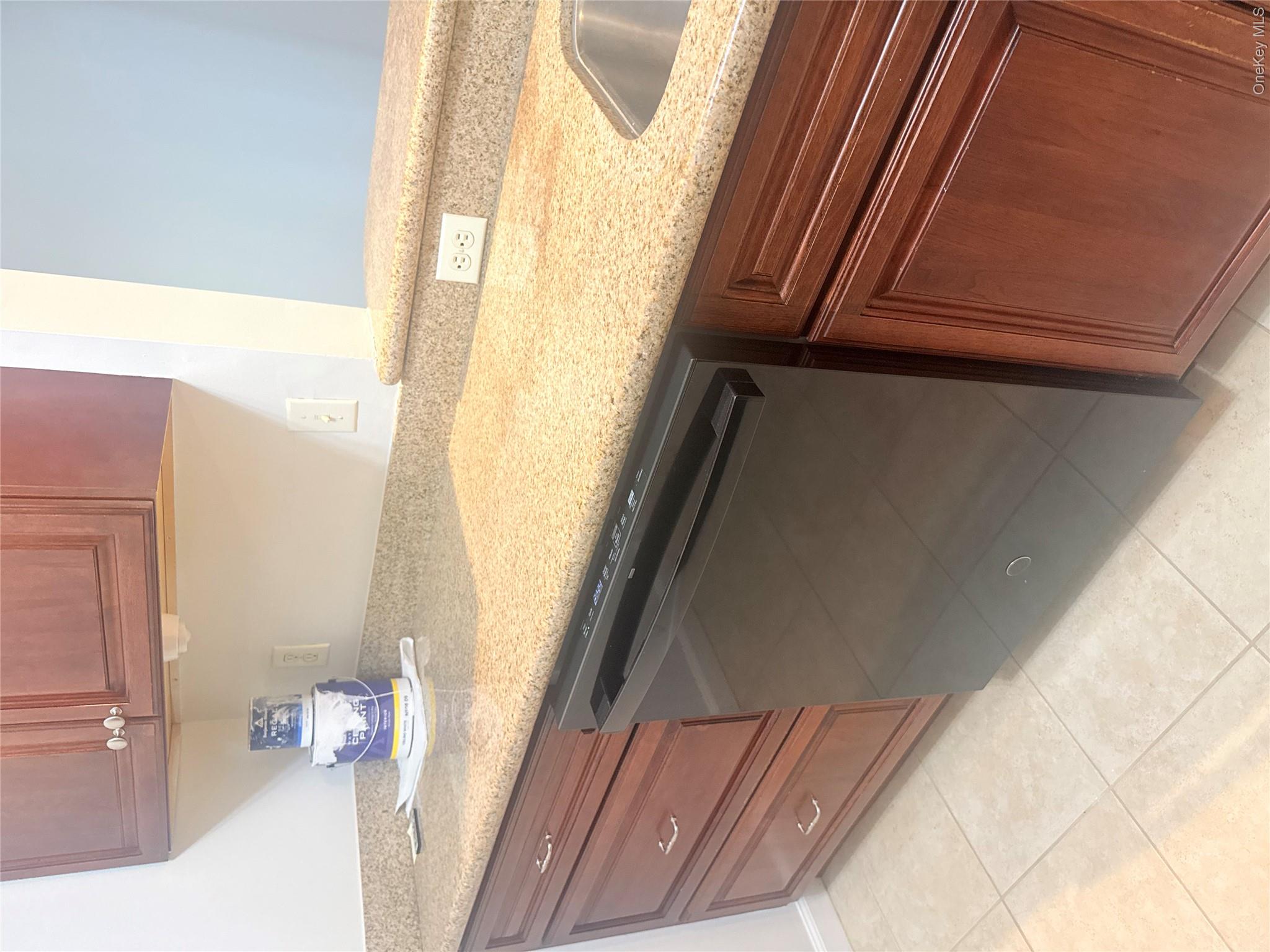 935 Tower Ridge Circle Middletown, NY 10941 - Photo 20 of 24 Kitchen featuring stone-finish countertops, wood cabinetry, a black dishwasher, and a stainless steel sink