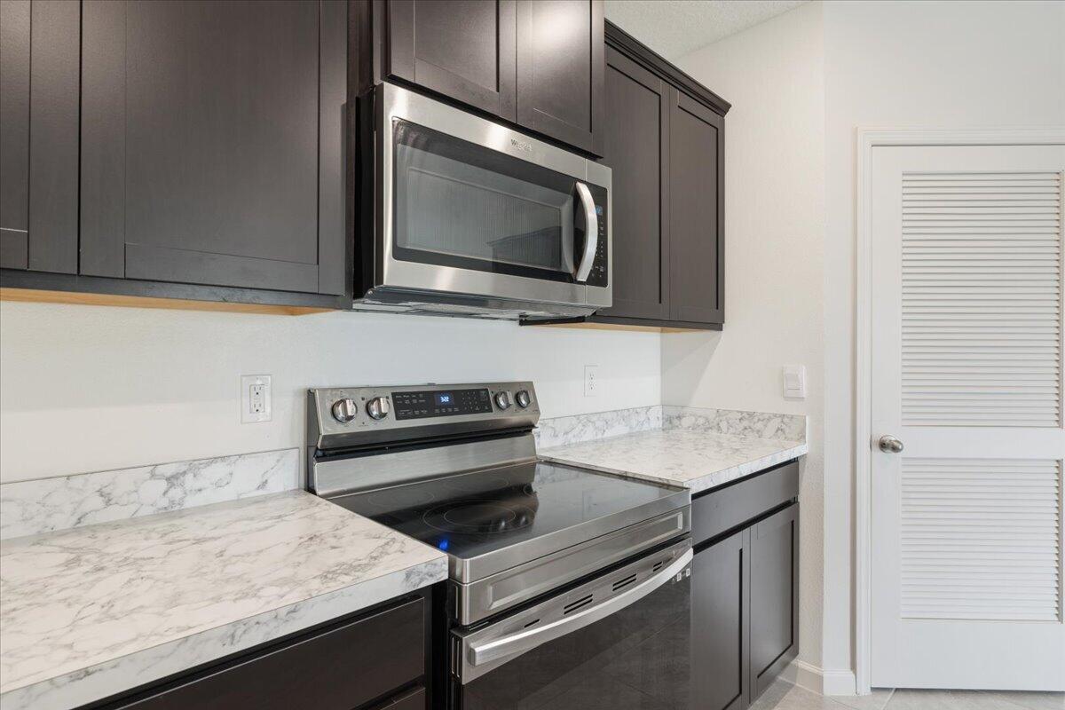 1072 Roseland Road Sebastian, FL 32958 - Photo 11 of 47 a kitchen with a stove microwave and sink