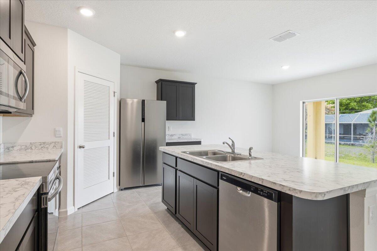 1072 Roseland Road Sebastian, FL 32958 - Photo 7 of 47 a kitchen with a sink and a refrigerator
