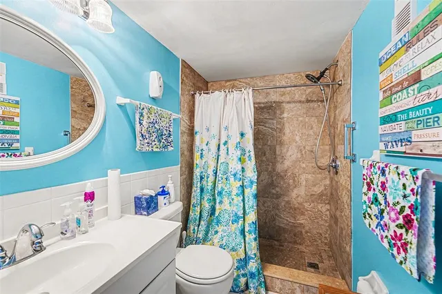 a bathroom with a sink toilet and shower