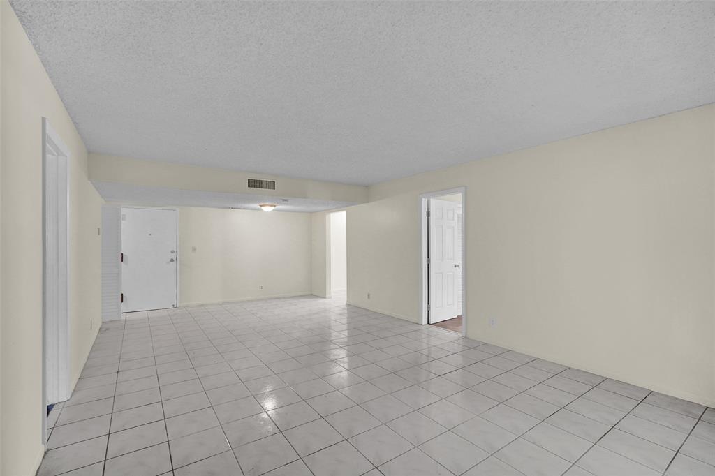 4218 Inverrary Boulevard, Unit 95B Lauderhill, FL 33319 - Photo 11 of 36 an empty room with white walls and tiles
