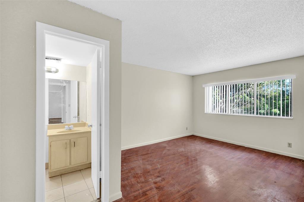 4218 Inverrary Boulevard, Unit 95B Lauderhill, FL 33319 - Photo 13 of 36 an empty room with a bathroom and a window