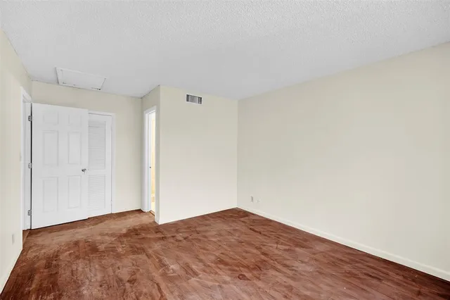 an empty room with wooden floor