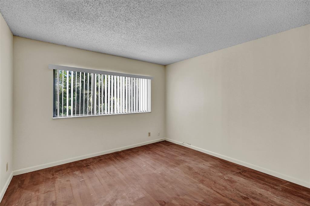 4218 Inverrary Boulevard, Unit 95B Lauderhill, FL 33319 - Photo 16 of 36 an empty room with wooden floor