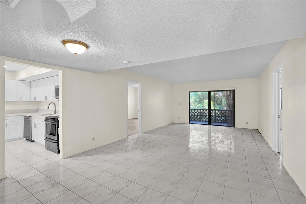 4218 Inverrary Boulevard, Unit 95B Lauderhill, FL 33319 - Photo 17 of 36 an empty room with windows and pillars in it