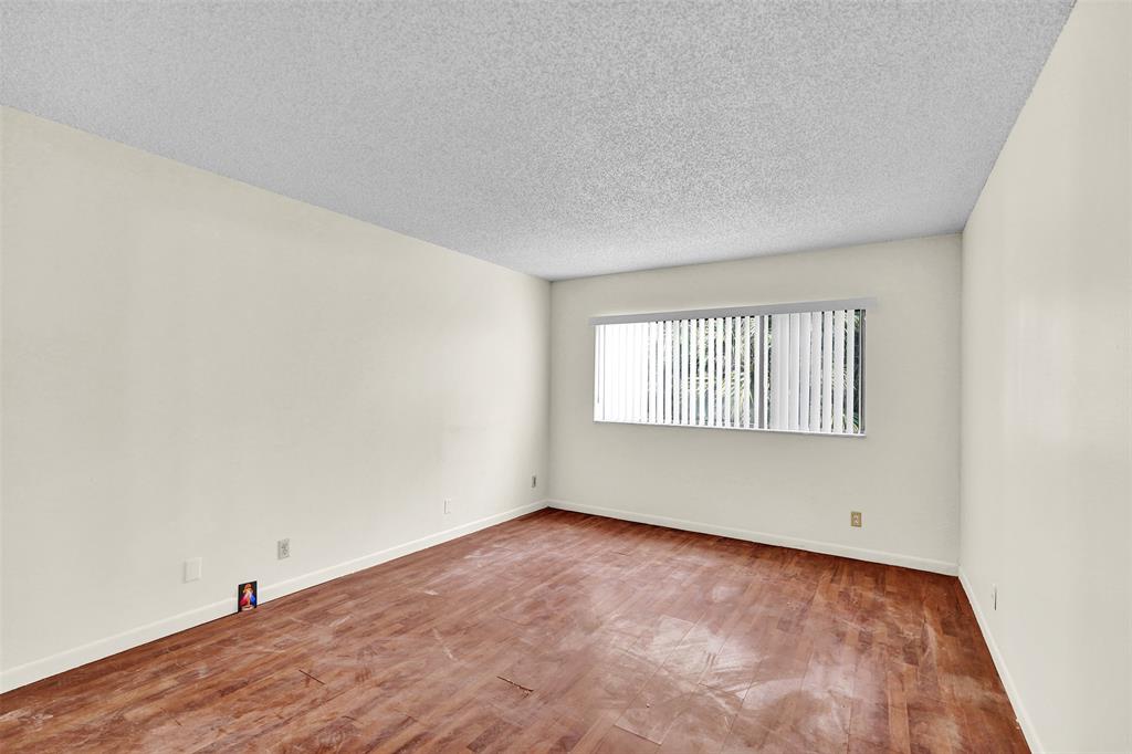 4218 Inverrary Boulevard, Unit 95B Lauderhill, FL 33319 - Photo 26 of 36 an empty room with a window
