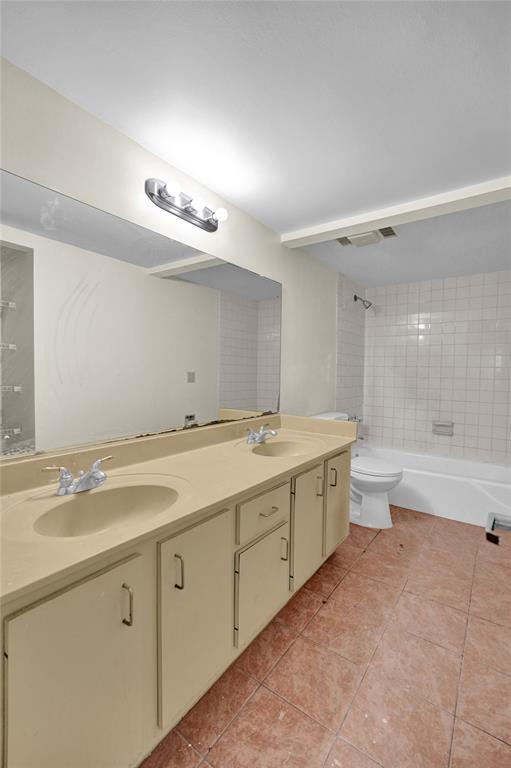 4218 Inverrary Boulevard, Unit 95B Lauderhill, FL 33319 - Photo 27 of 36 a spacious bathroom with a granite countertop sink a toilet a shower and a mirror