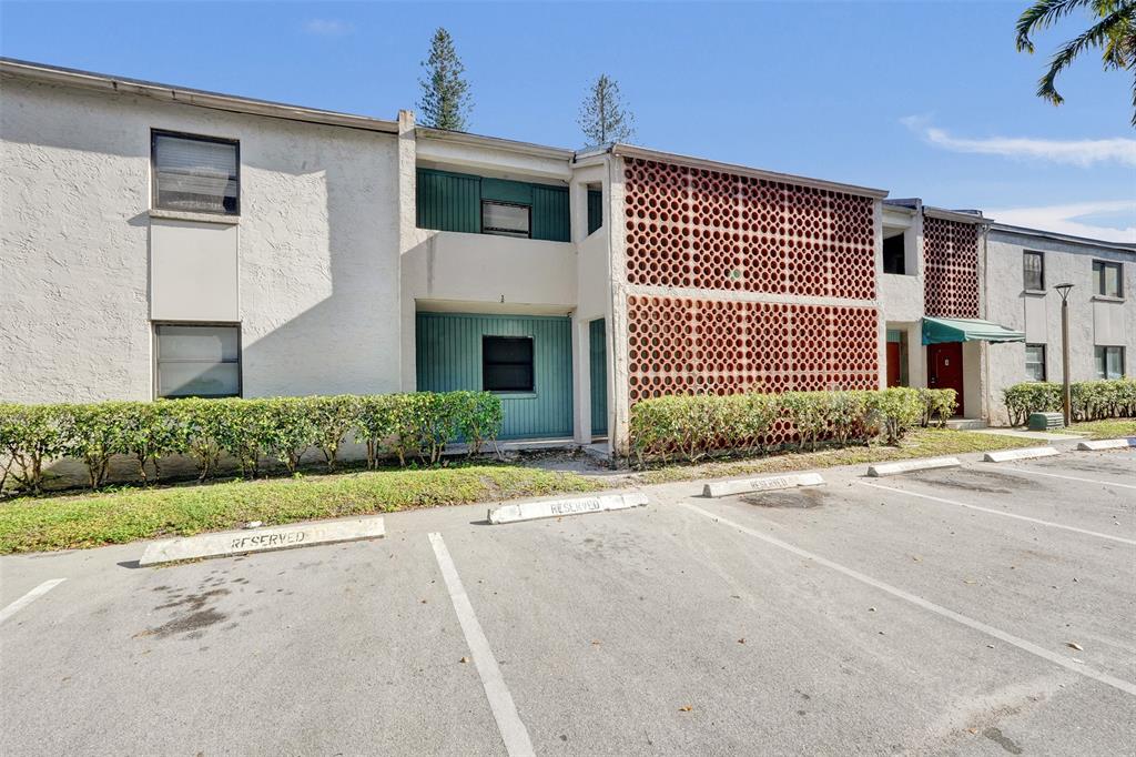 4218 Inverrary Boulevard, Unit 95B Lauderhill, FL 33319 - Photo 31 of 36 a front view of a house with a yard and garage