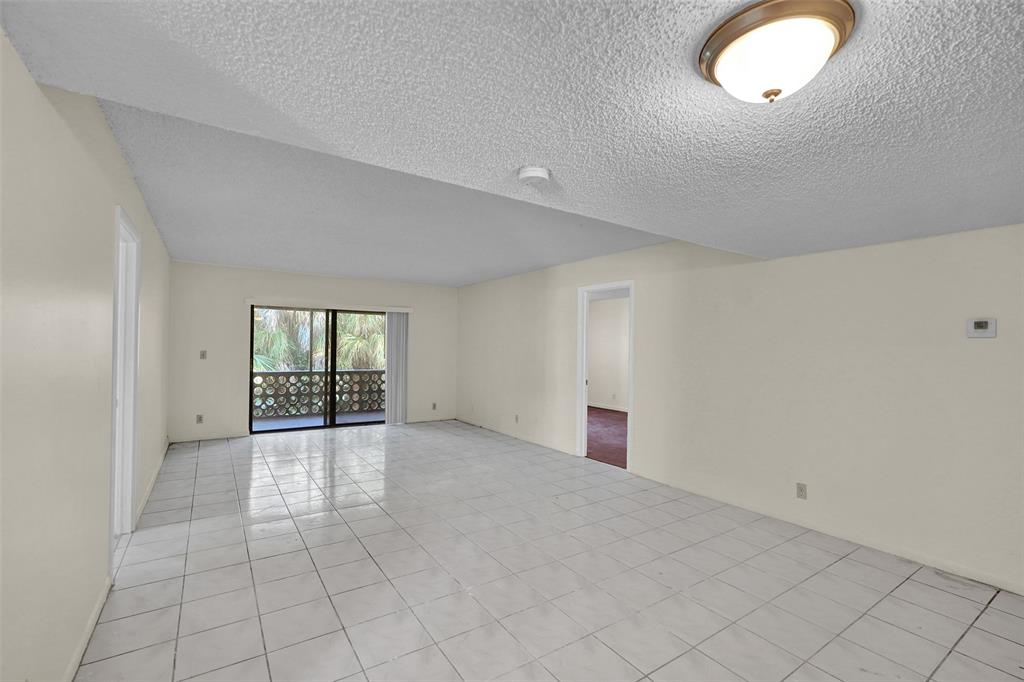 4218 Inverrary Boulevard, Unit 95B Lauderhill, FL 33319 - Photo 8 of 36 an empty room with windows and entrance