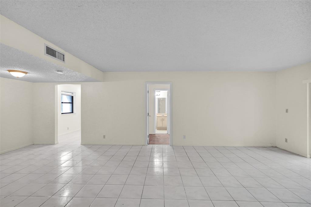 4218 Inverrary Boulevard, Unit 95B Lauderhill, FL 33319 - Photo 10 of 36 an empty room with windows