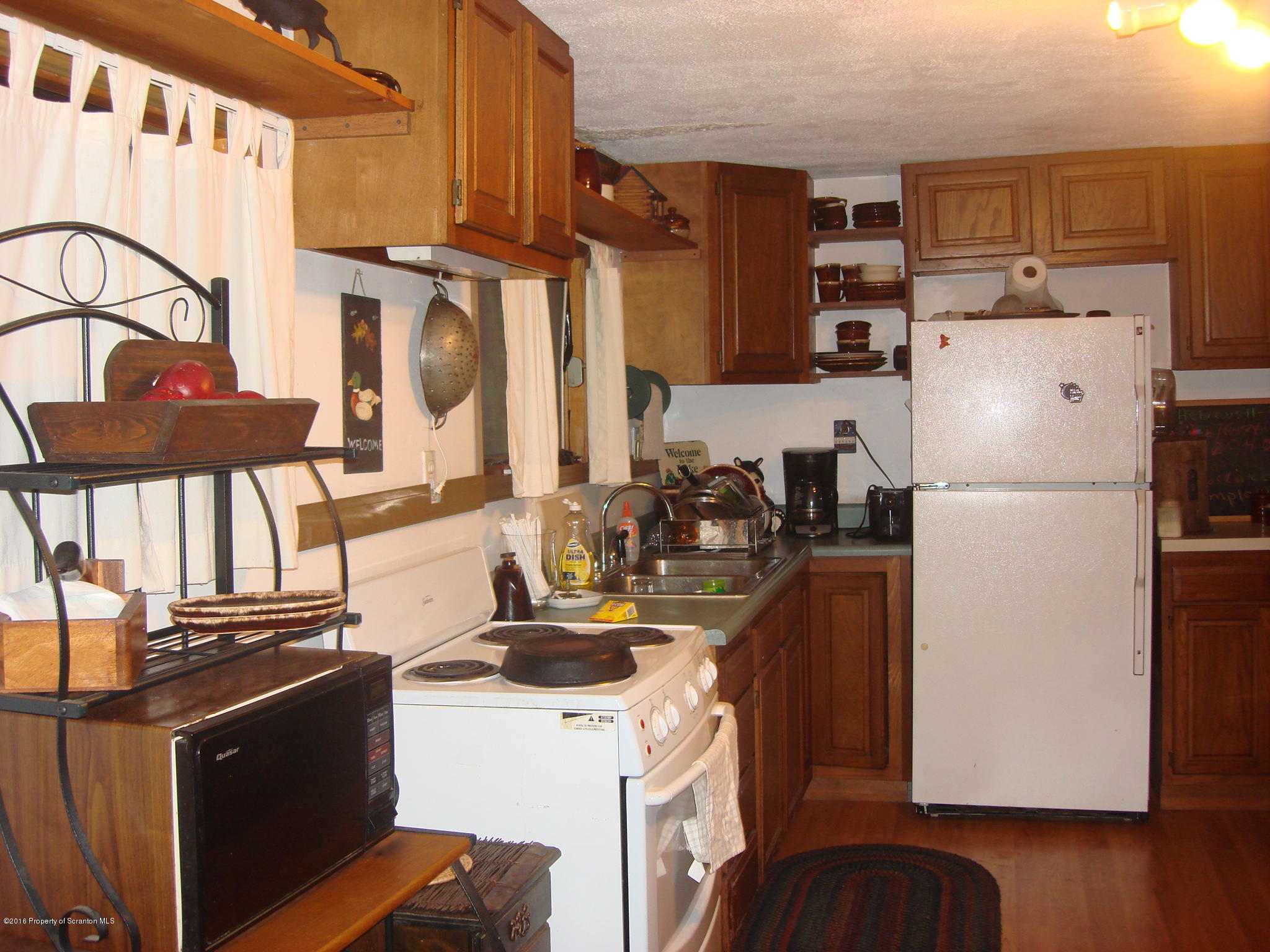 367 Crescent Lake Road Meshoppen, PA 18630 - Photo 5 of 23 a kitchen with stainless steel appliances granite countertop a refrigerator a stove a sink and a refrigerator