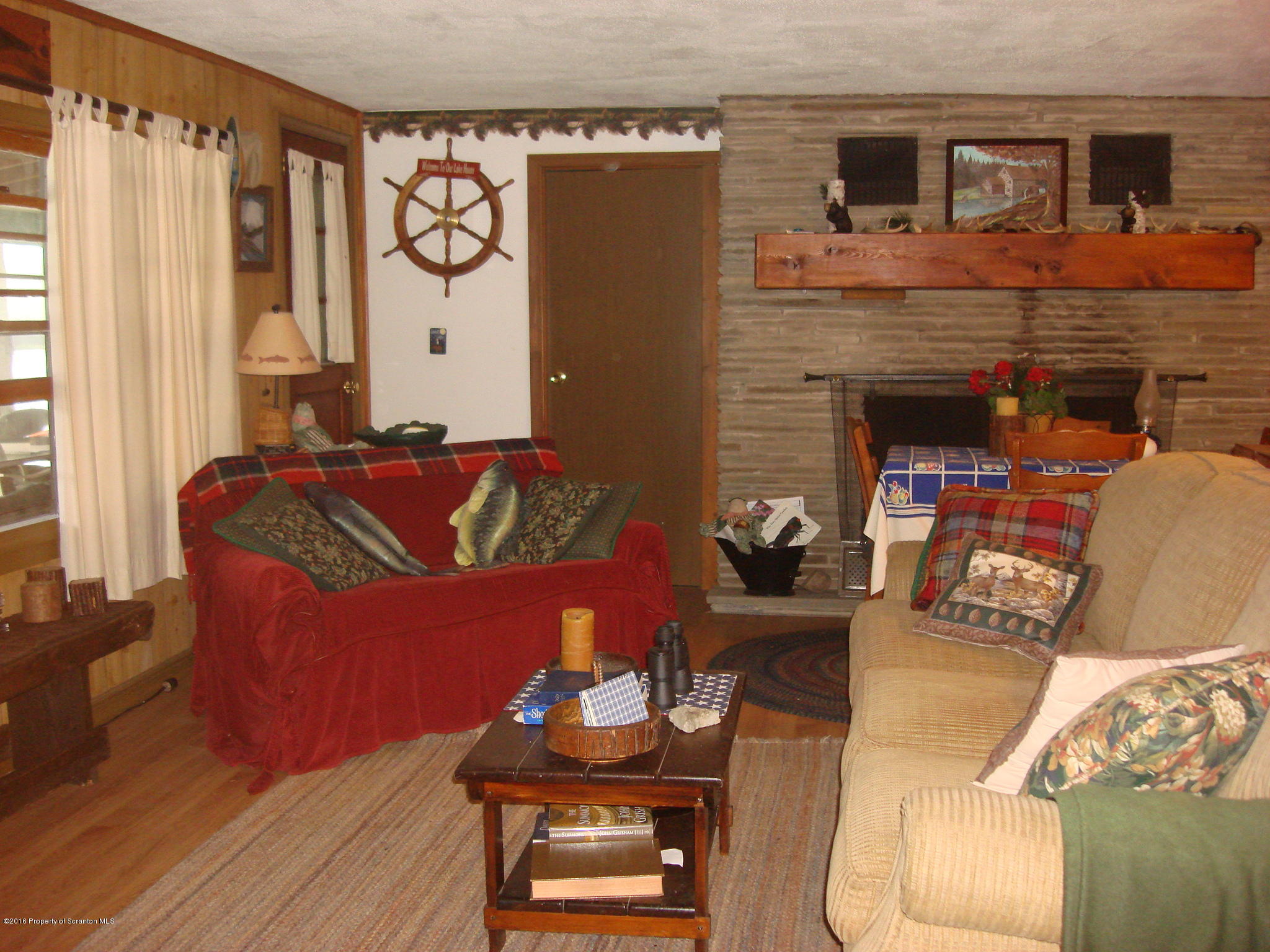 367 Crescent Lake Road Meshoppen, PA 18630 - Photo 8 of 23 a living room with furniture and a fireplace