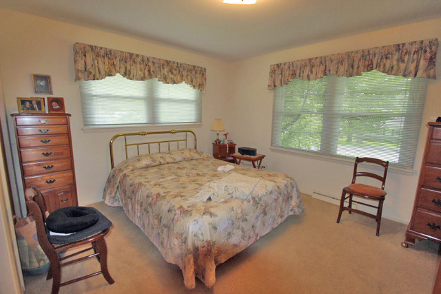 314 Banbury Road Mundelein, IL 60060 - Photo 8 of 17 a bedroom with a bed a chair and a large window
