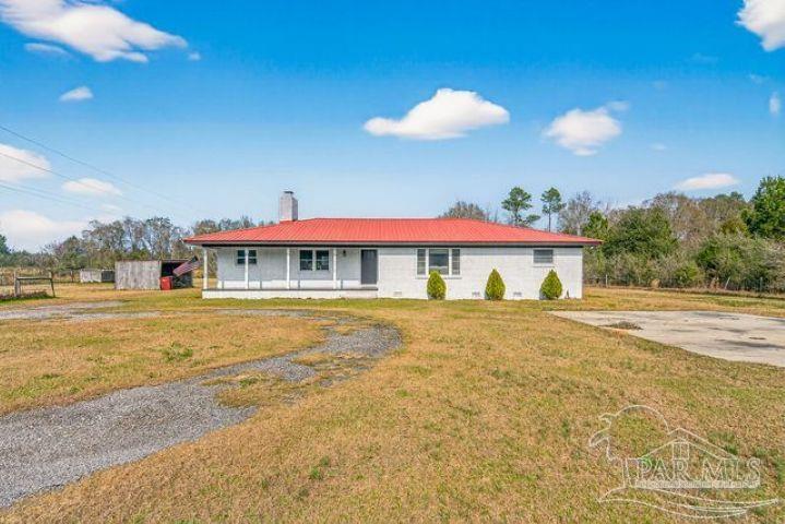 8940 Indian Ford Road Milton, FL 32570 - Photo 1 of 54 a front view of house with yard and entertaining space