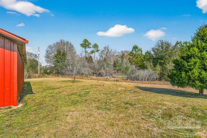 8940 Indian Ford Road Milton, FL 32570 - Photo 11 of 54 a view of a swimming pool with an outdoor space and seating area