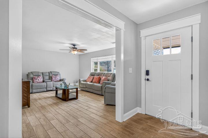 8940 Indian Ford Road Milton, FL 32570 - Photo 12 of 54 a living room with furniture and a wooden floor