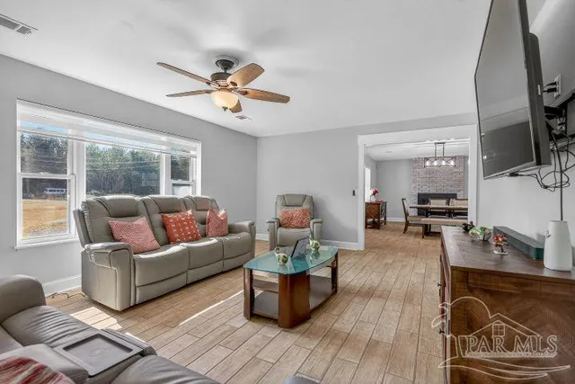 a living room with furniture and a flat screen tv