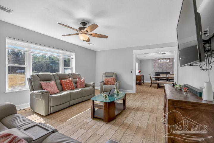 8940 Indian Ford Road Milton, FL 32570 - Photo 13 of 54 a living room with furniture and a flat screen tv