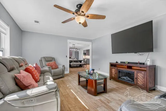 a living room with furniture and a flat screen tv