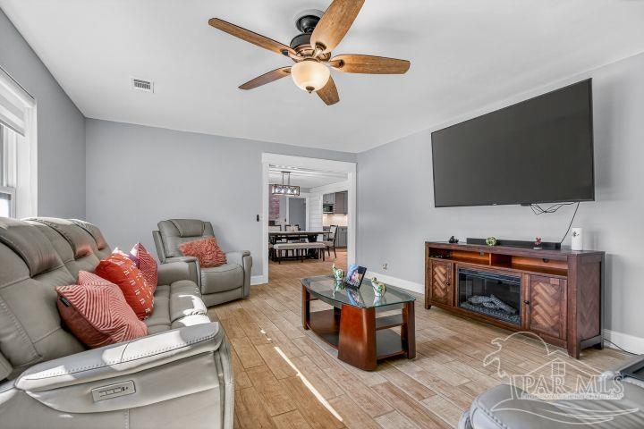 8940 Indian Ford Road Milton, FL 32570 - Photo 14 of 54 a living room with furniture and a flat screen tv
