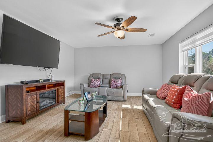 8940 Indian Ford Road Milton, FL 32570 - Photo 15 of 54 a living room with furniture and a flat screen tv