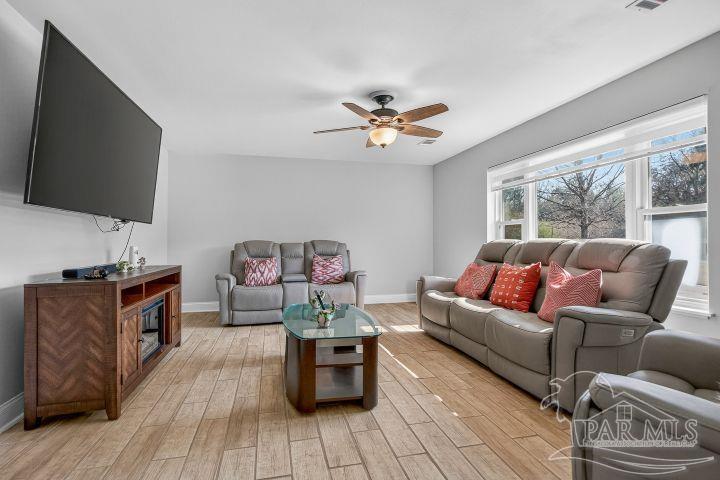 8940 Indian Ford Road Milton, FL 32570 - Photo 16 of 54 a living room with furniture and a flat screen tv