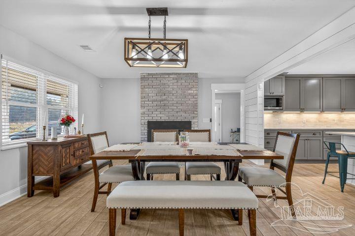 8940 Indian Ford Road Milton, FL 32570 - Photo 17 of 54 a view of a dining room with furniture window and wooden floor