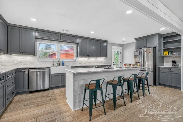 a kitchen with stainless steel appliances a refrigerator and a stove