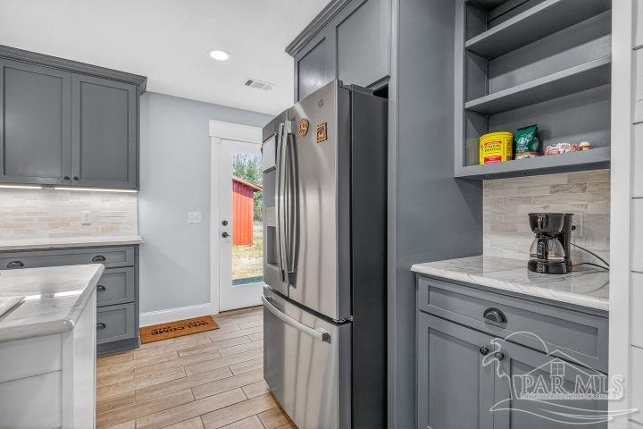 8940 Indian Ford Road Milton, FL 32570 - Photo 25 of 54 a kitchen with stainless steel appliances a refrigerator and a stove