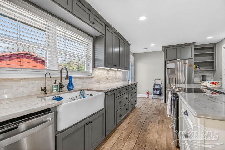 8940 Indian Ford Road Milton, FL 32570 - Photo 26 of 54 a kitchen with stainless steel appliances granite countertop a sink stove and cabinets
