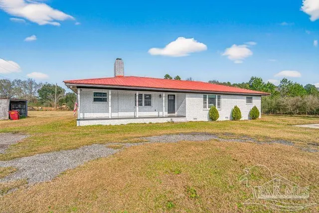 a view of house with swimming pool outdoor seating