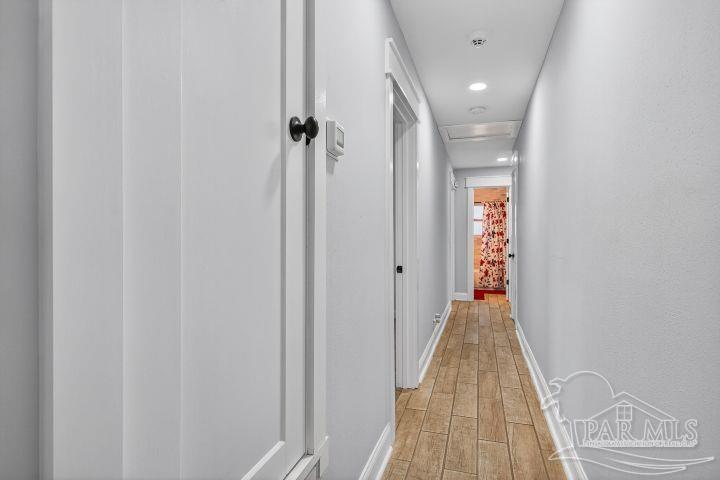 8940 Indian Ford Road Milton, FL 32570 - Photo 37 of 54 a view of a hallway with wooden floor and staircase