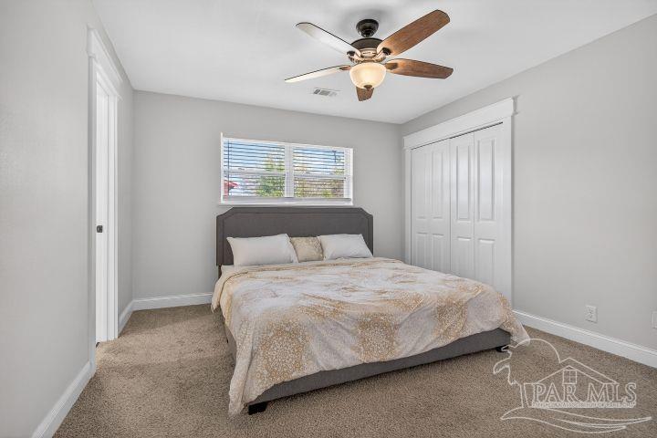 8940 Indian Ford Road Milton, FL 32570 - Photo 39 of 54 a bedroom with a bed and a chandelier