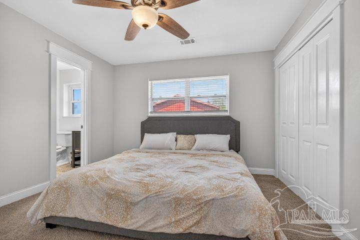 8940 Indian Ford Road Milton, FL 32570 - Photo 40 of 54 a bedroom with a large bed and a chandelier