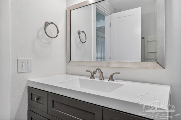 8940 Indian Ford Road Milton, FL 32570 - Photo 50 of 54 a bathroom with a sink and a mirror