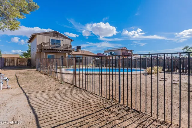 a view interior of a house with wooden floor a ceiling fan and windows