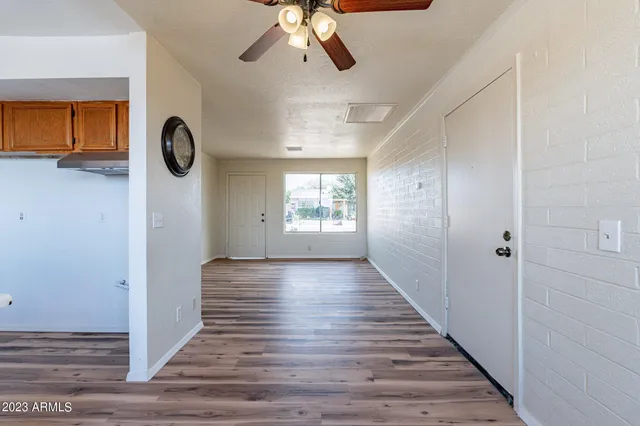 a view of a room with wooden floor and window