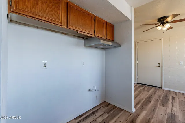 a view of a room with wooden floor