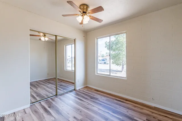 a view of a room with wooden floor
