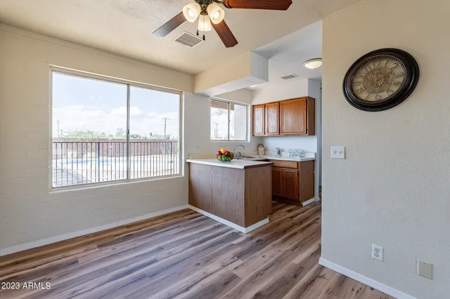 a kitchen with a wooden floor and a window