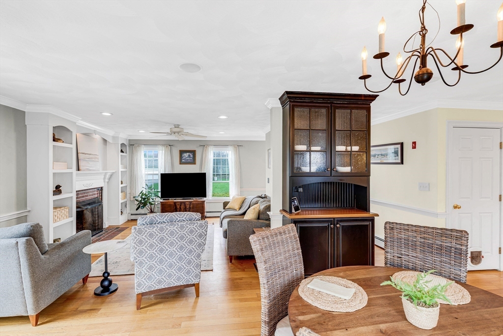54 Old Merrill Street Amesbury, MA 01913 - Photo 10 of 34 a living room with fireplace furniture and a wooden floor
