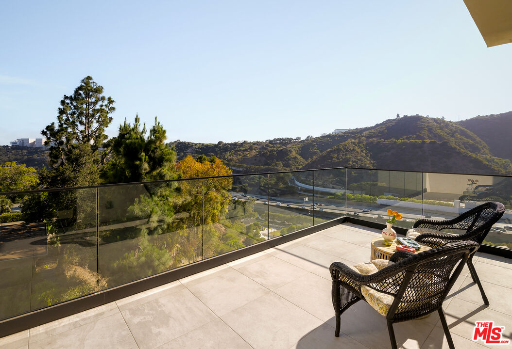 1367 Casiano Road Los Angeles, CA 90049 - Photo 20 of 26 a view of a swimming pool with a lounge chair