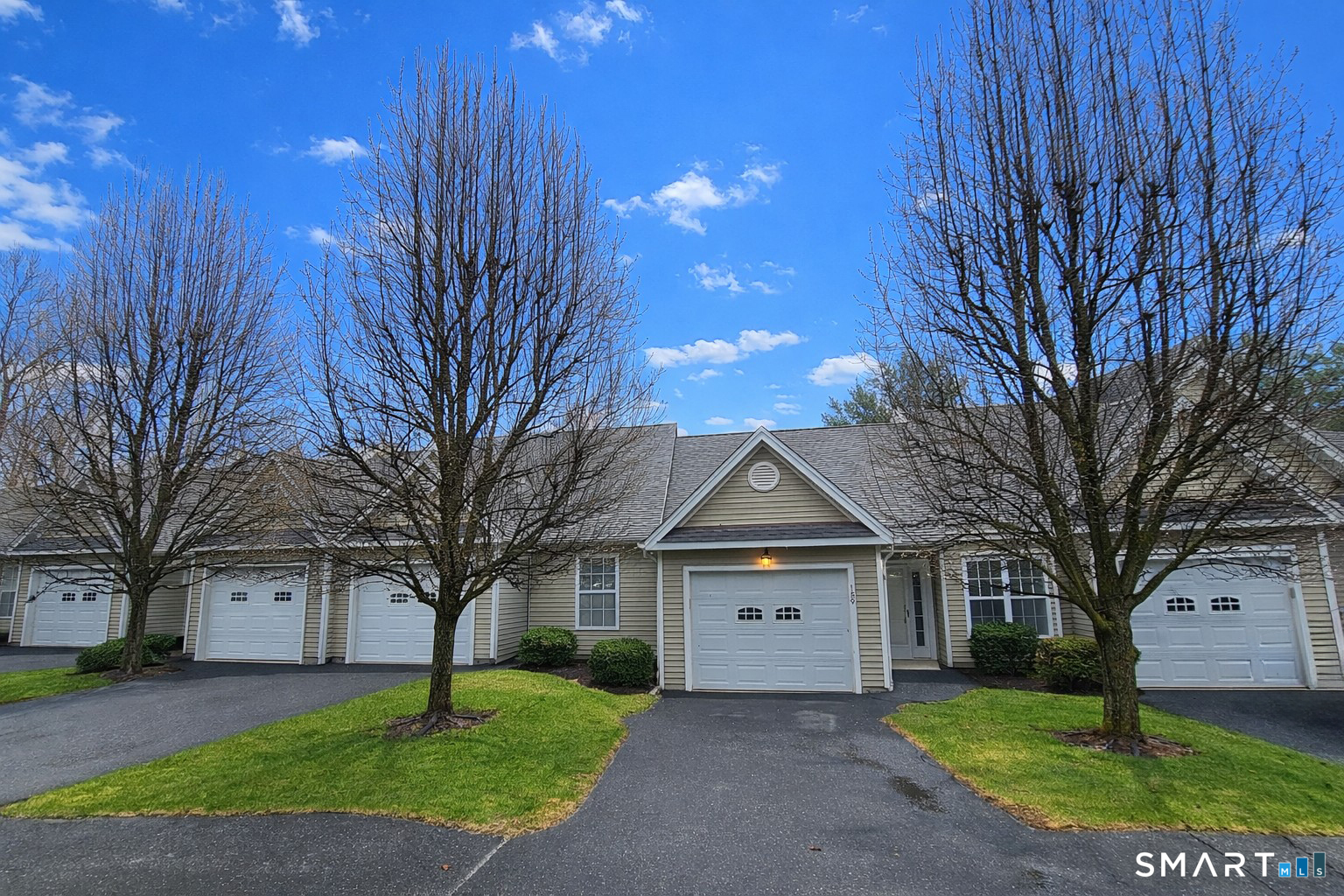 159 Jennifer Lane, Unit 159 Newtown, CT 06482 - Photo 2 of 28 a front view of a house with a yard and tree