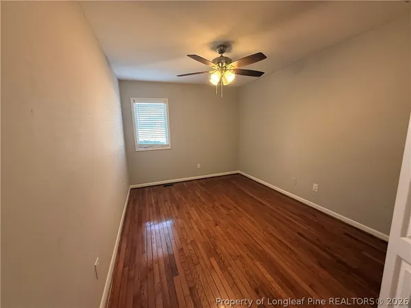 a view of a room with wooden floor and window