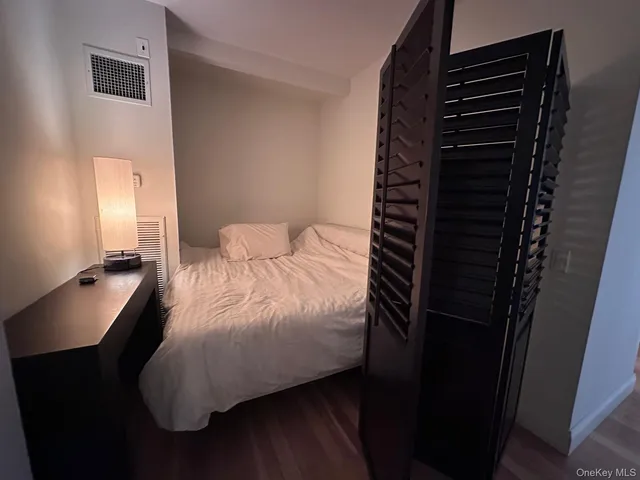 a bedroom with a bed and a night stand