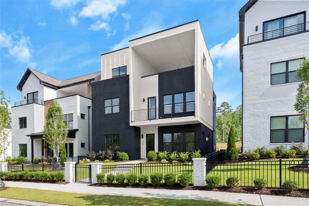 326 Treble Way Alpharetta, GA 30009 - Photo 2 of 47 a front view of a building with a garden and plants
