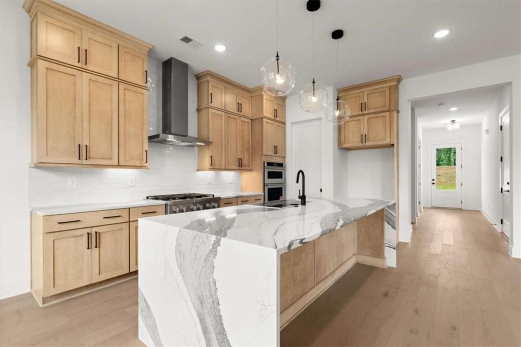 326 Treble Way Alpharetta, GA 30009 - Photo 9 of 47 a large kitchen with stainless steel appliances granite countertop a stove a sink a refrigerator and white cabinets with wooden floor