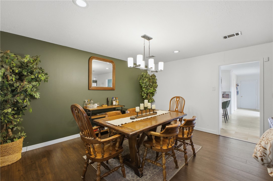 2012 Red River Drive Bryan, TX 77802 - Photo 10 of 23 a view of a dining room with furniture and wooden floor