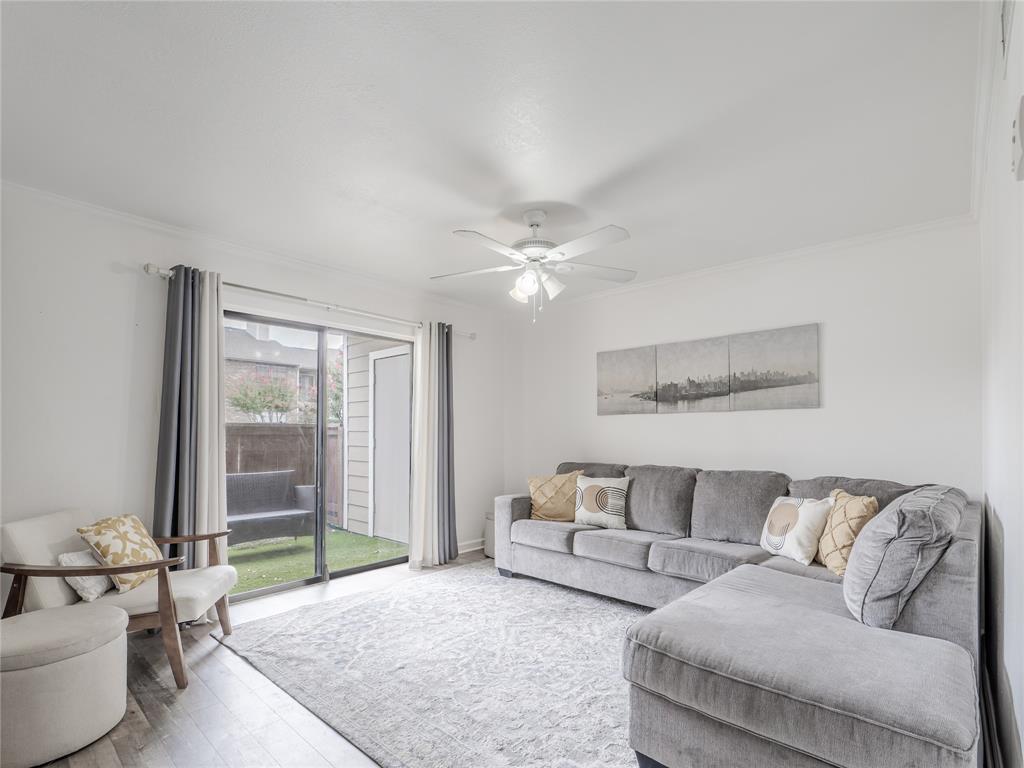 4748 Old Bent Tree Lane, Unit 201 Dallas, TX 75287 - Photo 2 of 17 Living room featuring ceiling fan, wood finished floors, and crown molding
